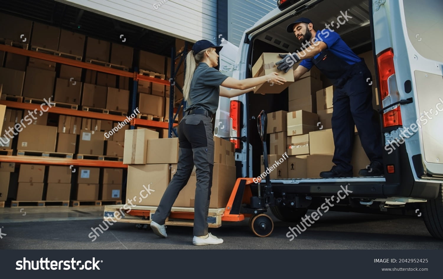 stock-photo-outside-of-logistics-distributions-warehouse-diverse-team-of-workers-use-hand-truck-loading-2042952425 (1)